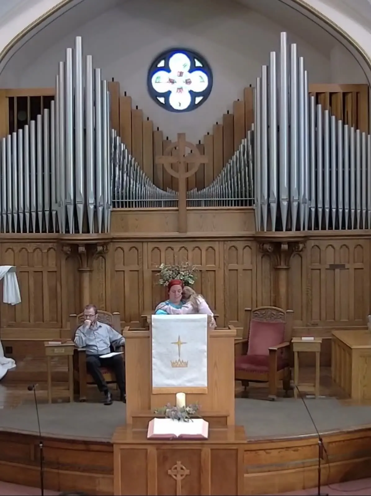 Participant reading a passage during Easter service 2026.